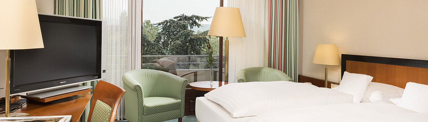 Superior room Bright hotel room at Maritim Hotel Bad Salzuflen with double bed, seating area and balcony access