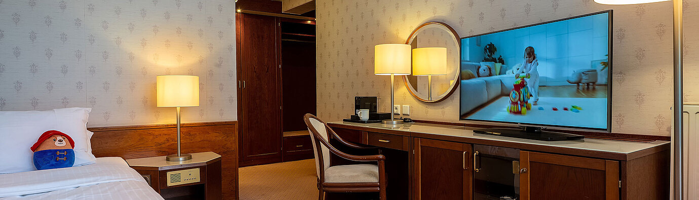 Superior Family room Superior family room with bed, large TV, desk and cosy seating area for a comfortable stay.