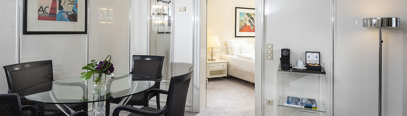 Suite Executive  Bright Executive Suite at Maritim Hotel Frankfurt with stylish dining area, glass table, and direct access to the bedroom.