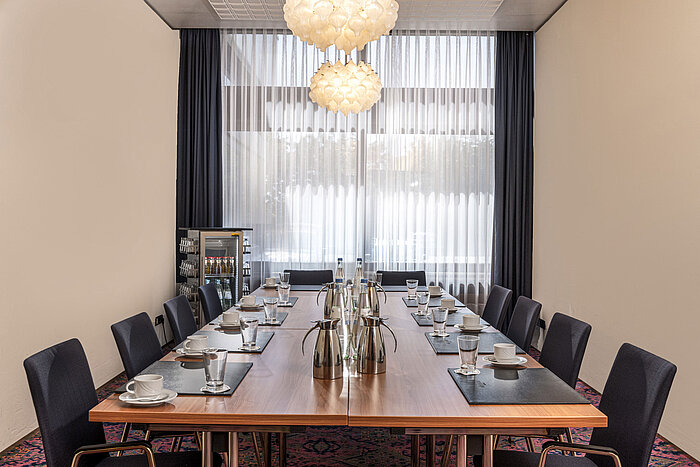 Small conference room with large window, daylight and drinks station at Maritim Hotel Travemünde