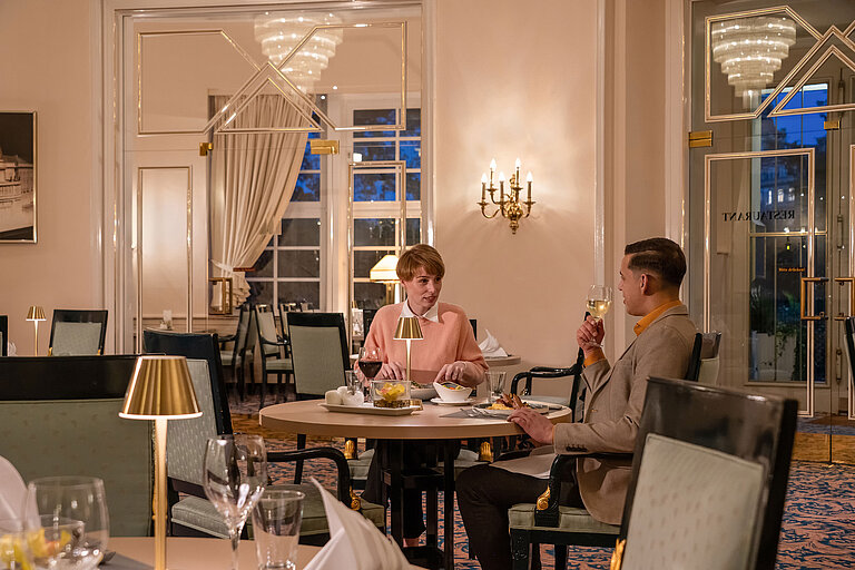 Café-Restaurant "Classic" Guests dining in the Café-Restaurant Classic, enjoying a cosy evening in an elegant, warmly lit setting.