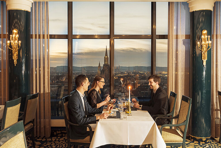 Panorama and Bastei Restaurant Guests enjoy dinner with a view of Ulm Minster at the restaurant of the Maritim Hotel Ulm