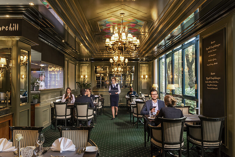 L'Echalote Restaurant  Guests enjoying fine dining in the elegant L'Echalote restaurant at Maritim Hotel Bremen's stylish setting.