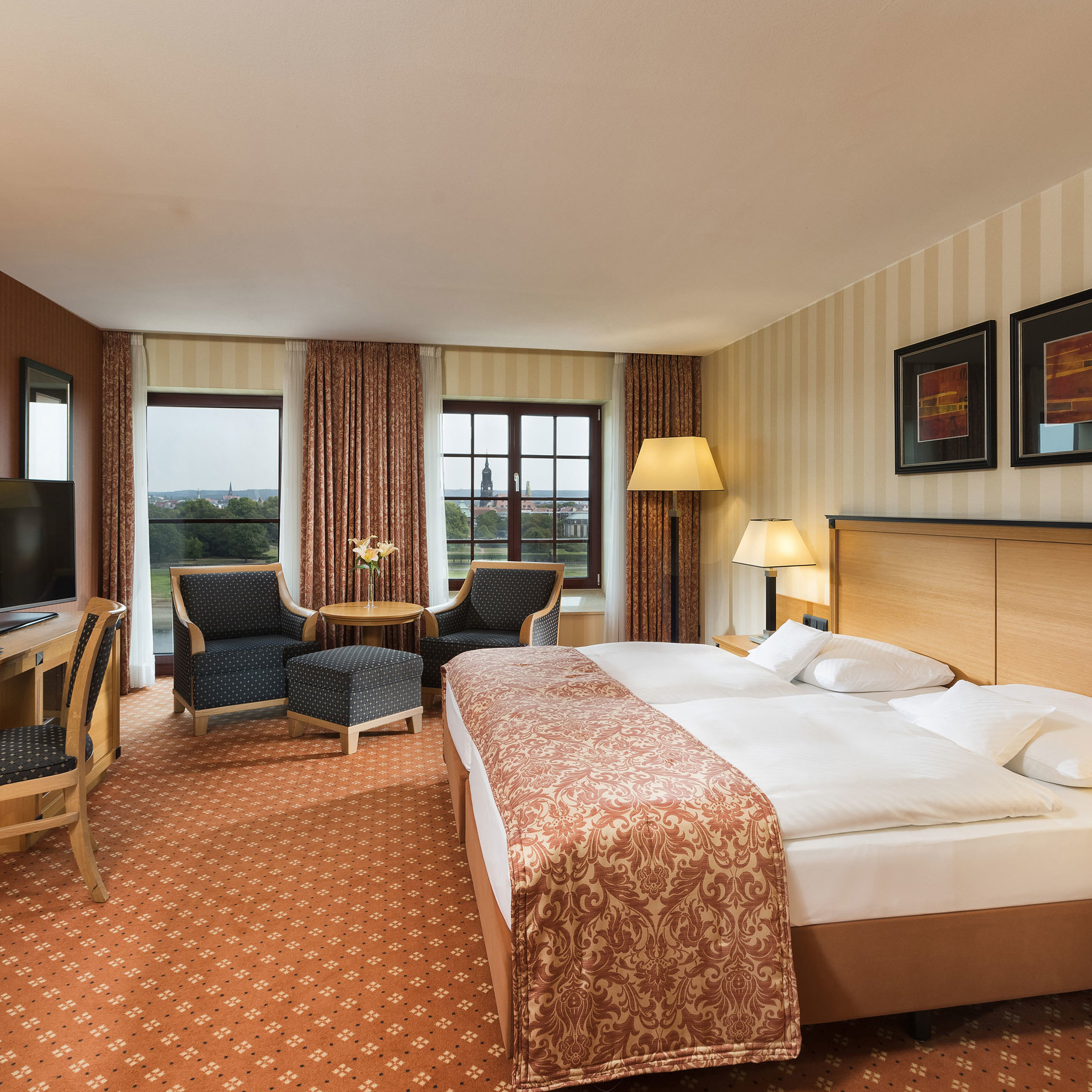 Superior room Superior room at Maritim Hotel Dresden with elegant double bed, desk, and seating area with city view.