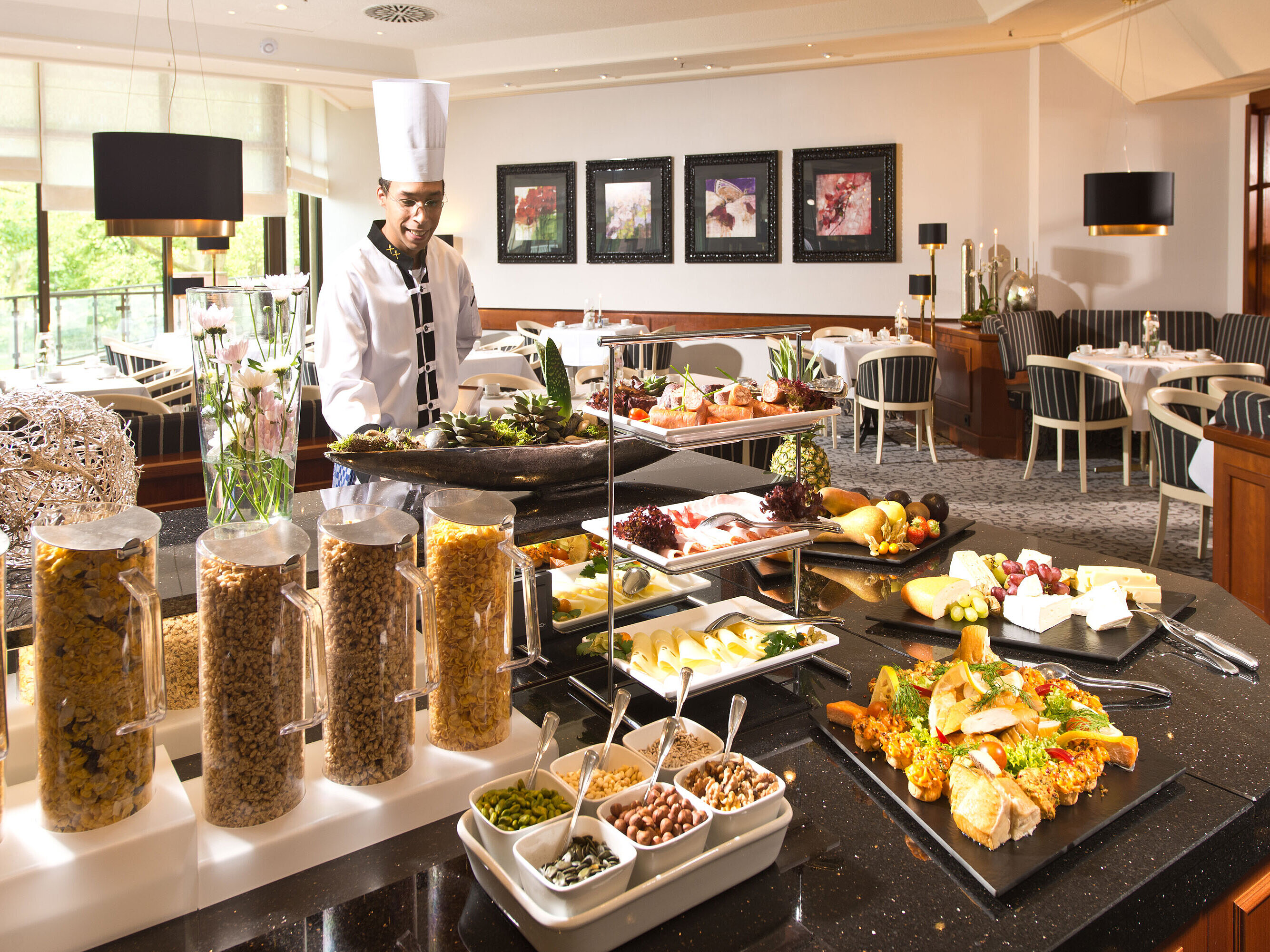 Breakfast buffet at Maritim Hotel Bad Homburg with fresh dishes, cereals and a friendly chef.