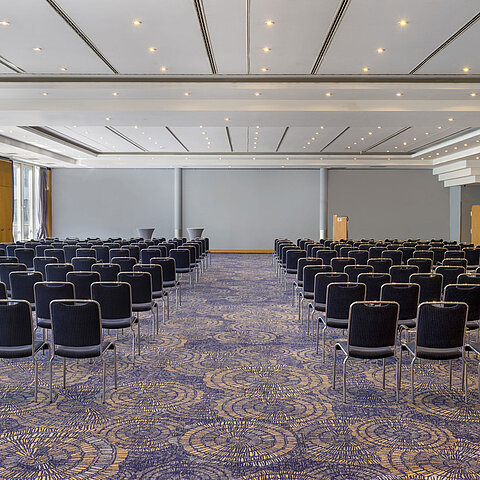 Large conference room Hall II at Maritim proArte Hotel Berlin with rows of chairs and bright ambiance, perfect for meetings.