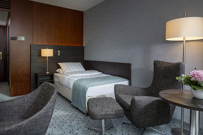 Superior room Superior single room at Maritim Hotel Bremen with modern design, comfortable chairs, and elegant lighting.
