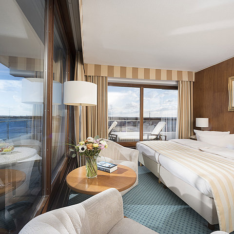 Superior room at Maritim Seehotel Timmendorfer Strand with sea view, double bed, seating area, and balcony.