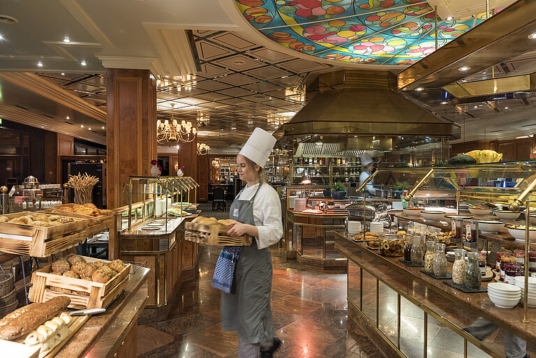 Brasserie Restaurant  Breakfast buffet at Maritim Hotel Bremen with fresh bread rolls, bread,and a selection of breakfast dishes,attended by a chef