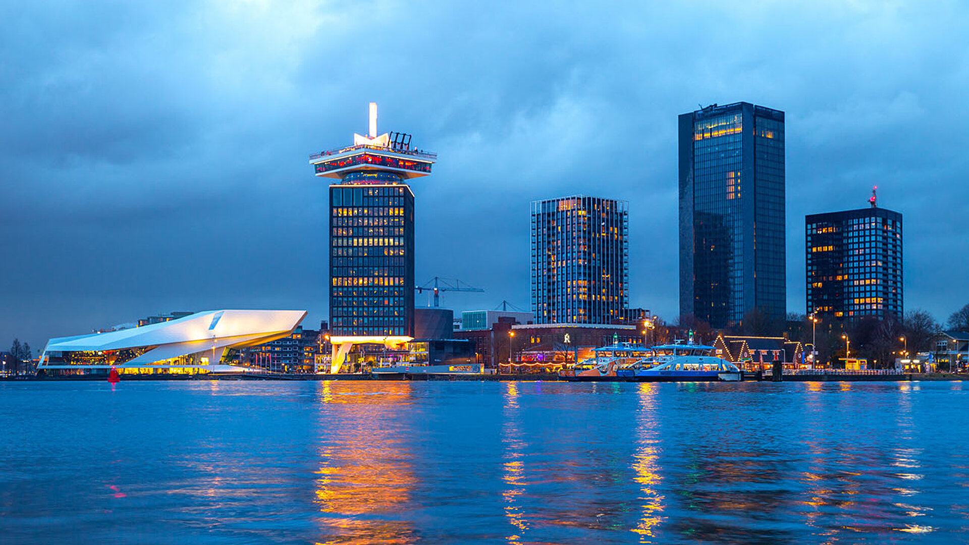Evening skyline of Amsterdam with A’DAM Tower and Eye Filmmuseum on the IJ