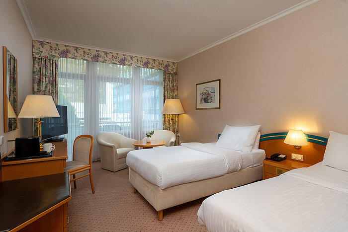 Comfort Twin room Comfort Twin room with two single beds, desk, seating area and large window for plenty of daylight.