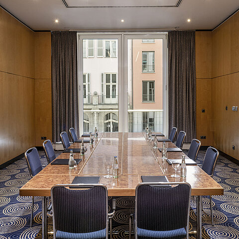 Bright meeting room Salon I at Maritim proArte Hotel Berlin with a large conference table and outside view.