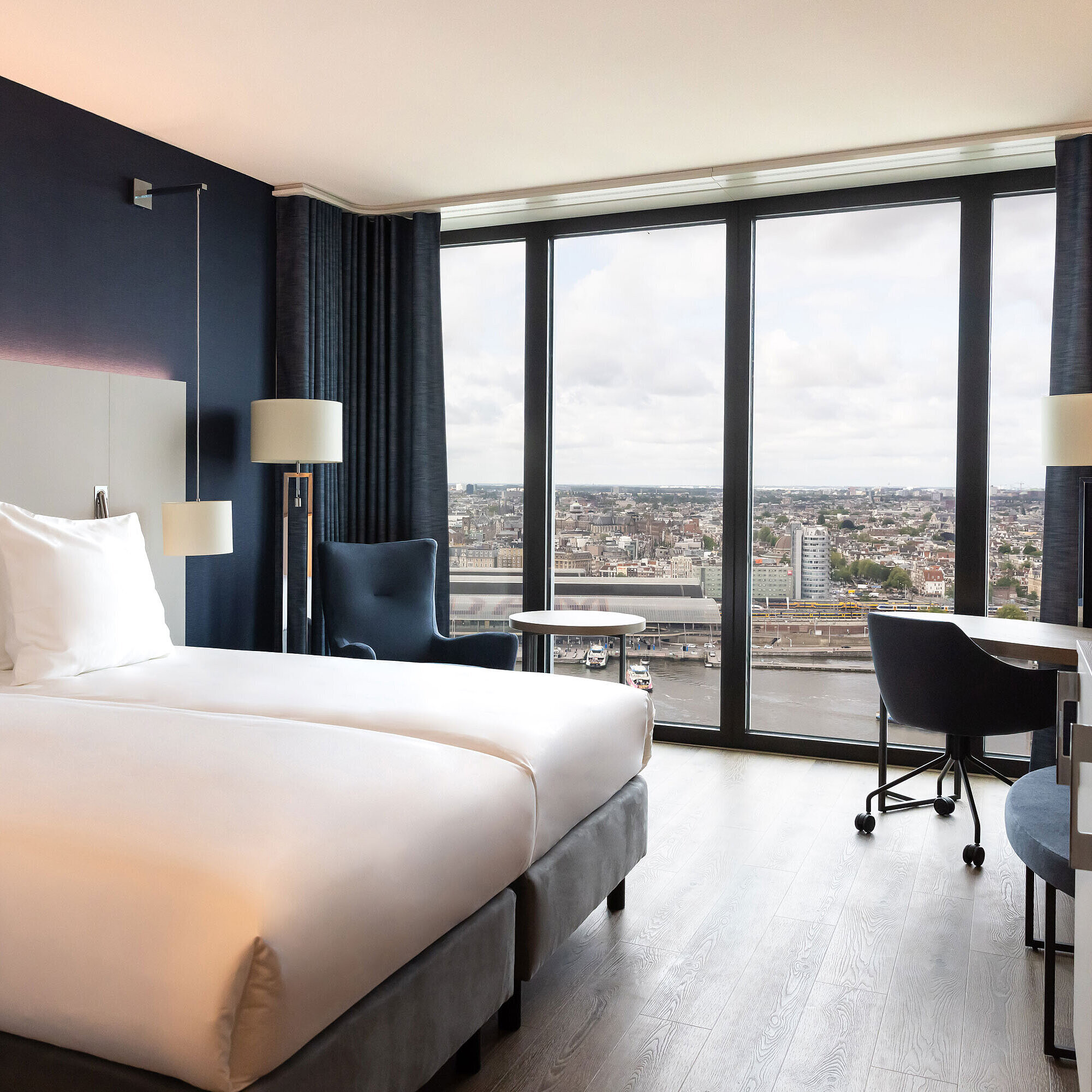 Twin room in Maritim Hotel Amsterdam with large window and panoramic city view