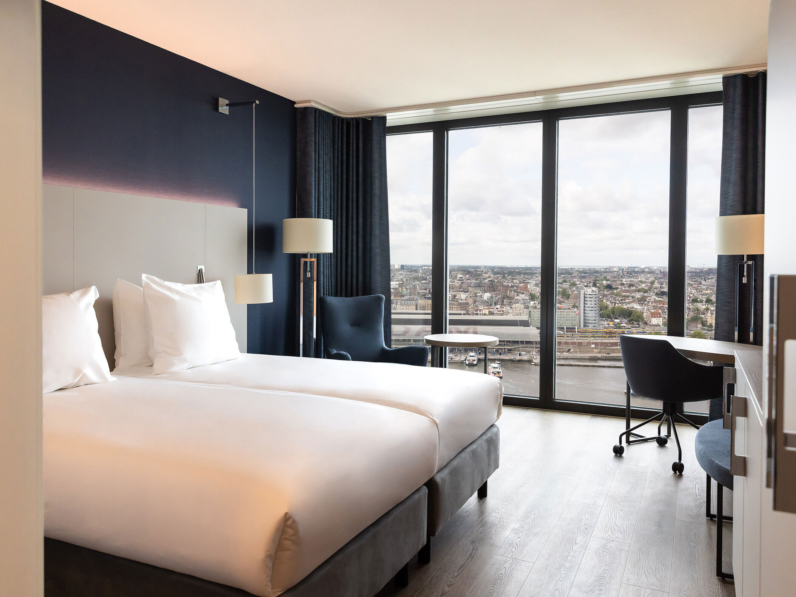 Twin room in Maritim Hotel Amsterdam with large window and panoramic city view