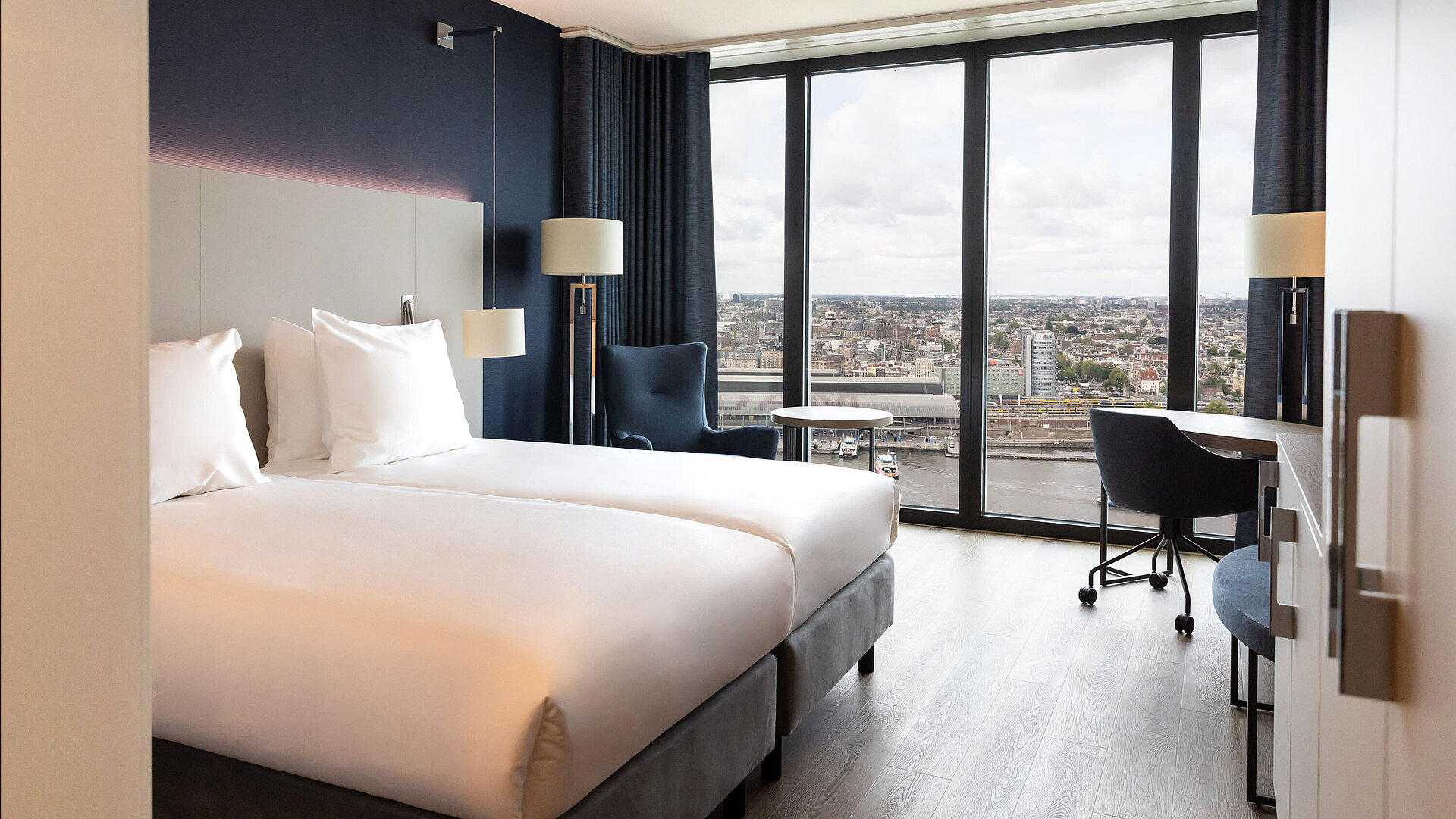 Twin room in Maritim Hotel Amsterdam with large window and panoramic city view