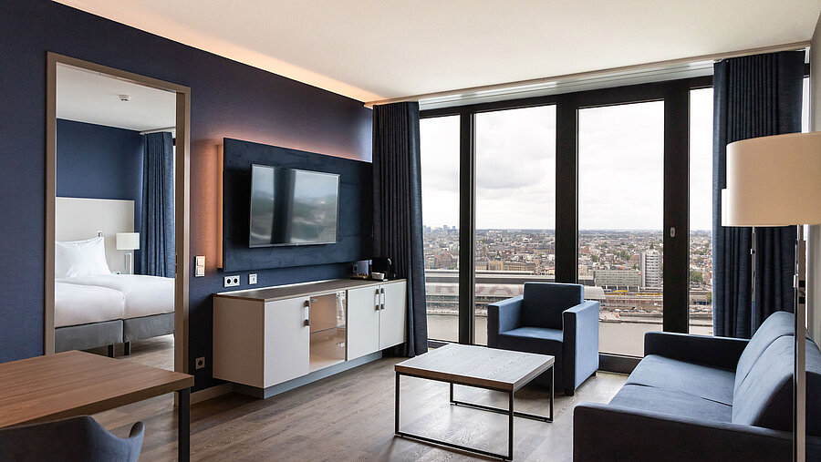 Modern living area with city view and TV at Maritim Hotel Amsterdam