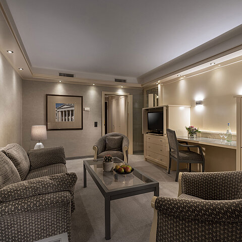 Elegant suite at Maritim Hotel Darmstadt with cozy seating area, stylish lighting, and desk for business or leisure stays.