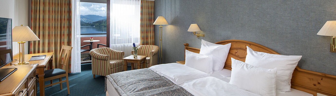 Spacious room at Maritim TitiseeHotel with seating area and view of Lake Titisee