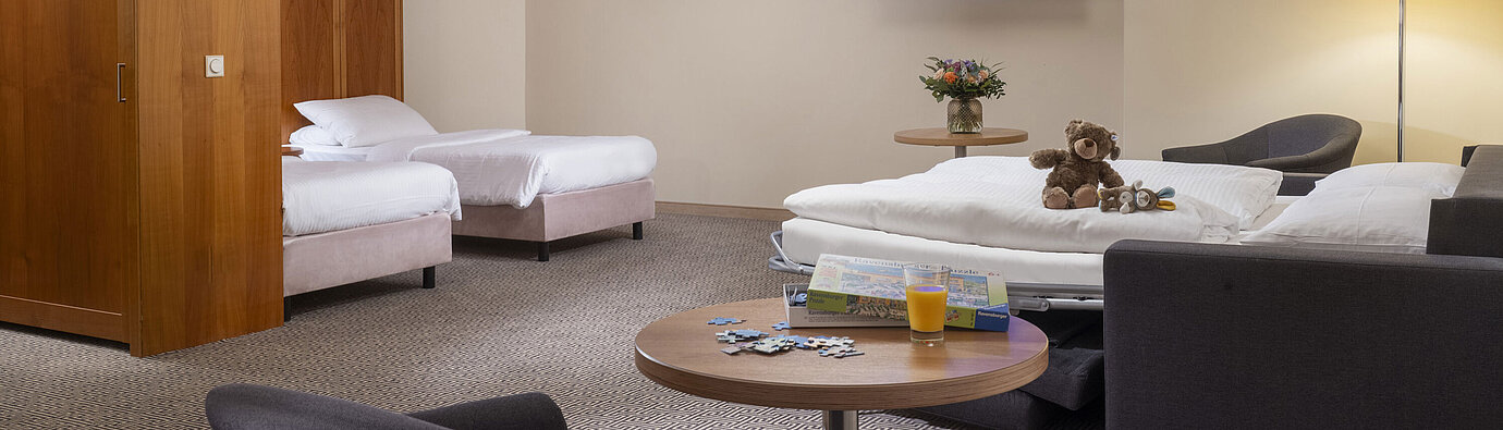 Family room Large family room with TV, sofa bed, toys and puzzle at the Maritim Hotel Stuttgart
