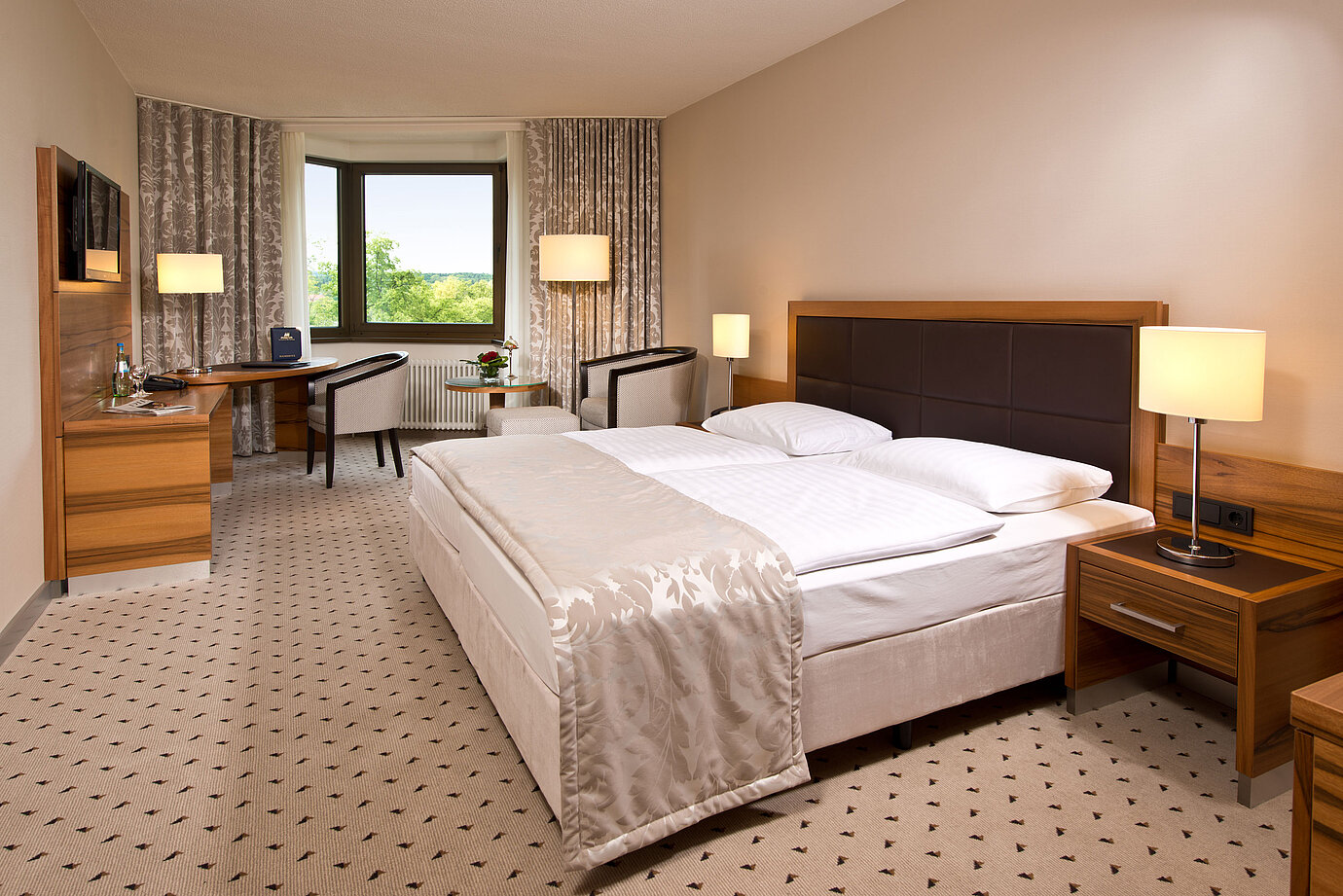 Comfortable hotel room at Maritim Hotel Bad Homburg with modern design and green view.
