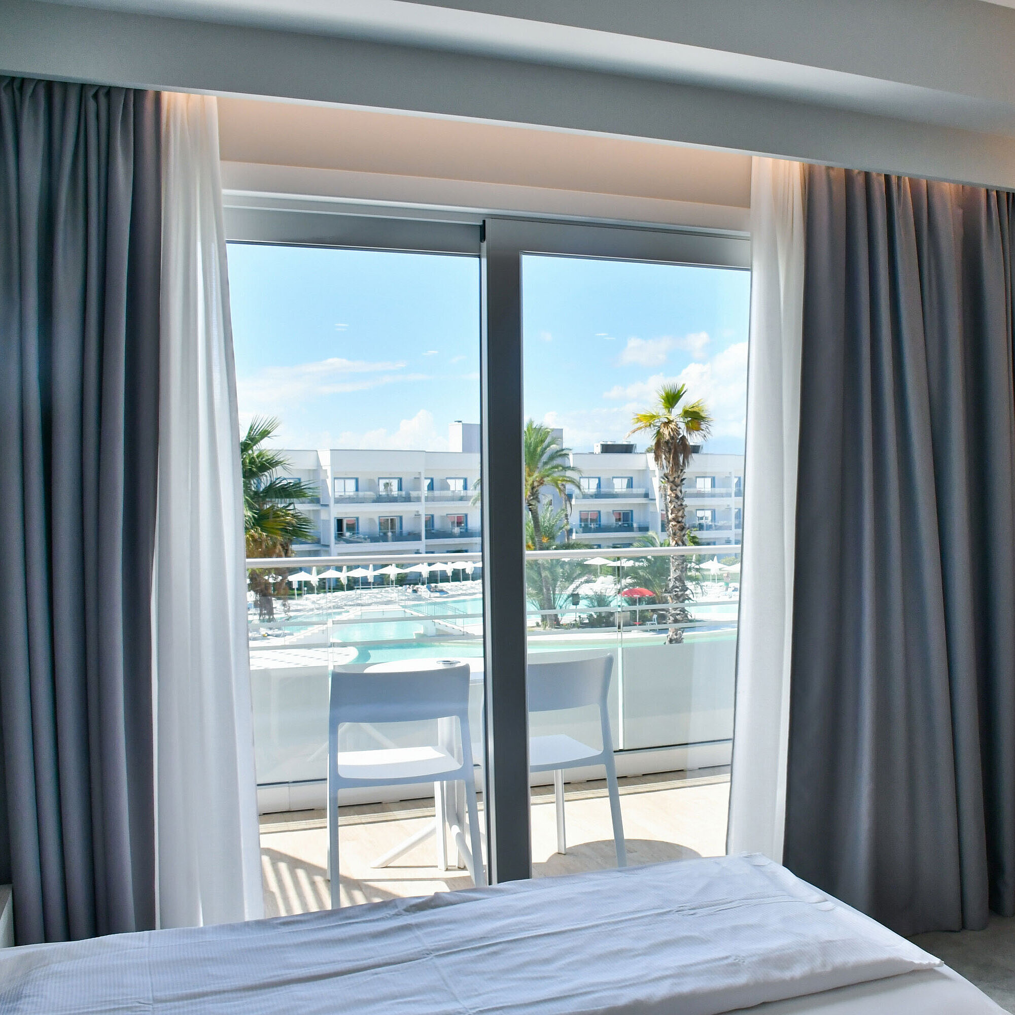 Poolview room Modern hotel room with balcony and direct view of the pool at Maritim Resort Calabria
