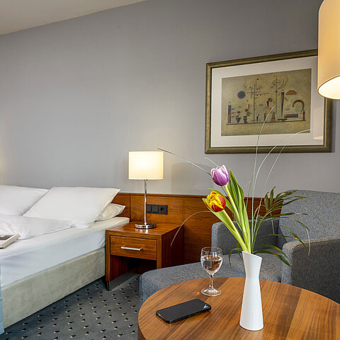 Comfort double room at Maritim Hotel Darmstadt with stylish decor, cozy seating area, and modern accents.