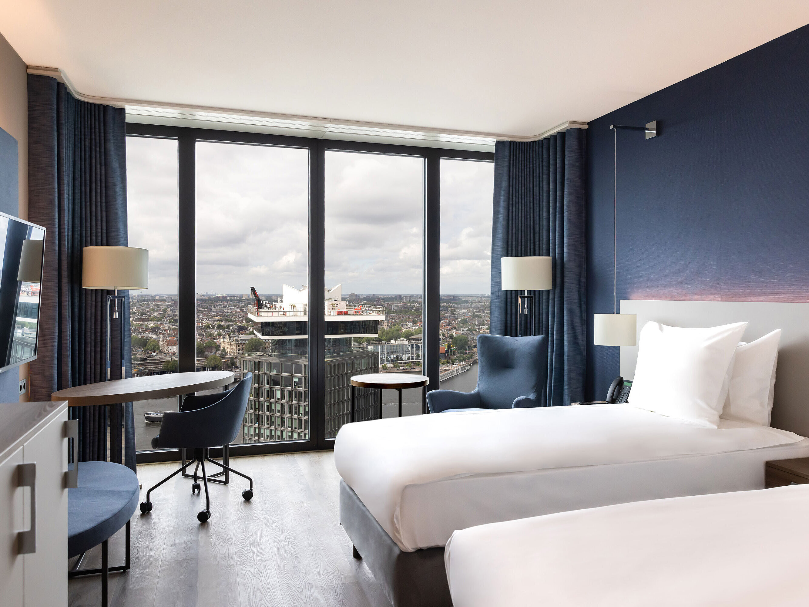 Modern twin room in Maritim Hotel Amsterdam with panoramic city and river view