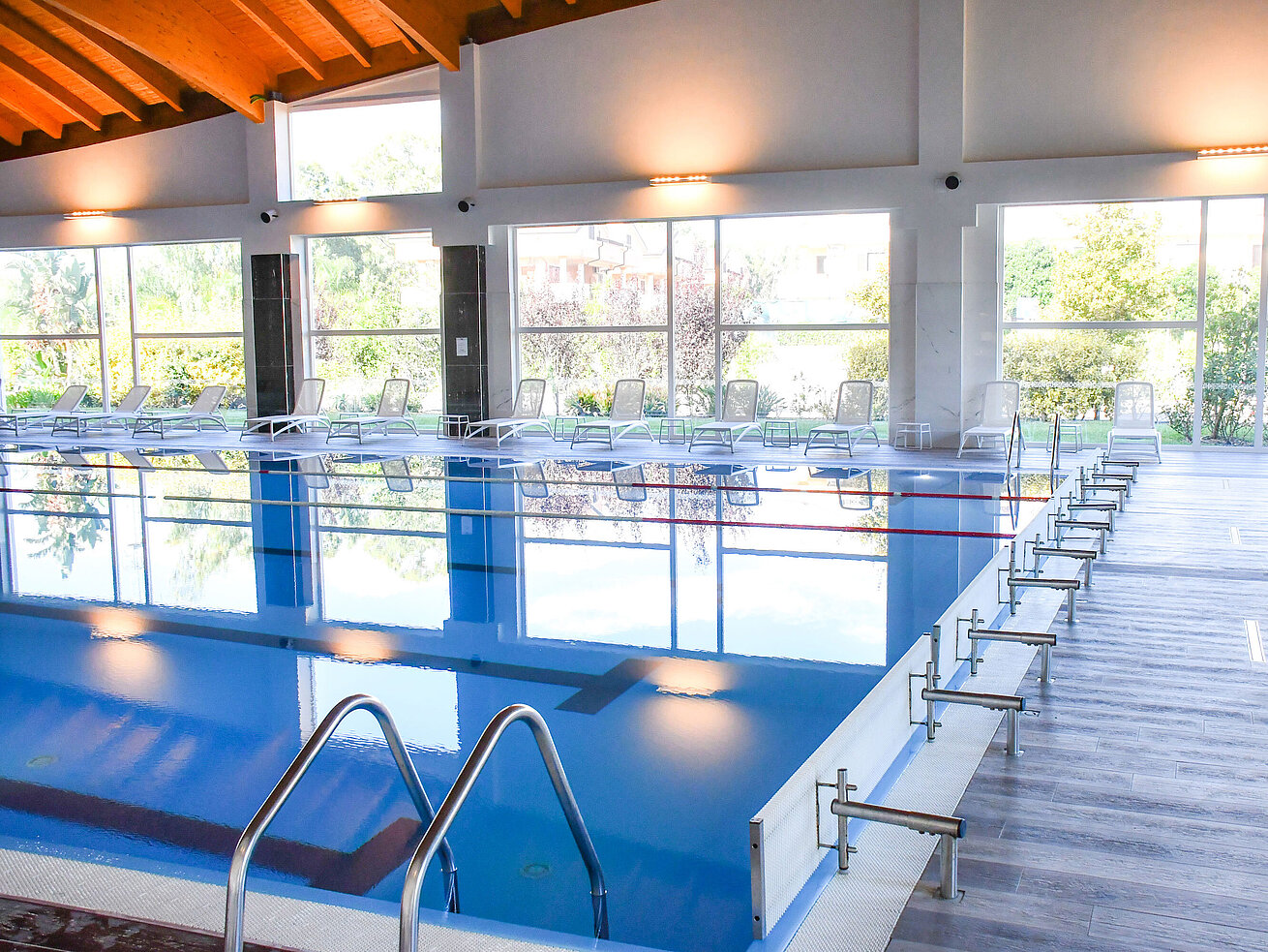 Indoor pool Modern indoor pool with large windows and loungers at the resort