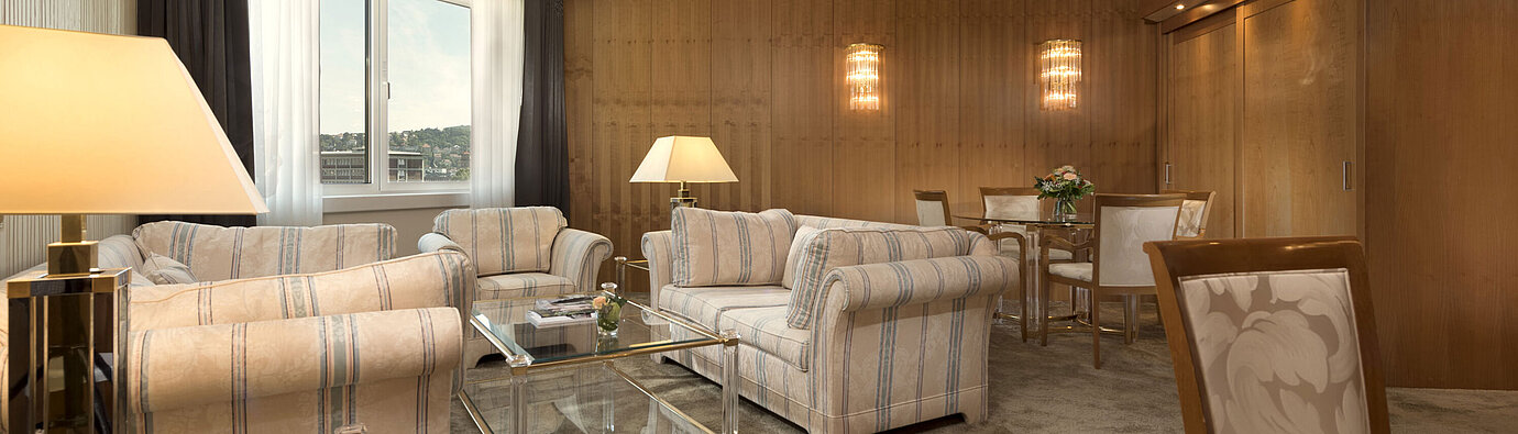 Classic suite Spacious living room with large window and seating area at Maritim Hotel Stuttgart