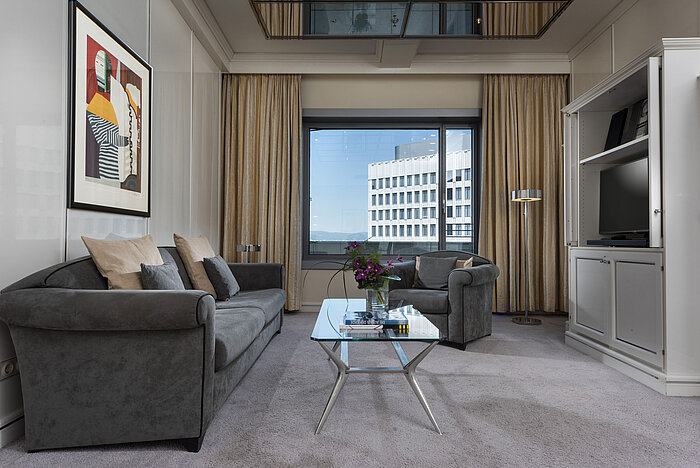 Executive Suite Spacious Executive Suite at Maritim Hotel Frankfurt with elegant decor, cozy seating area, and panoramic window.