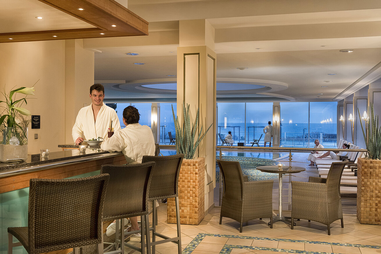 Pool  Spa area with pool and guests in bathrobes at Maritim Seehotel Timmendorfer Strand.