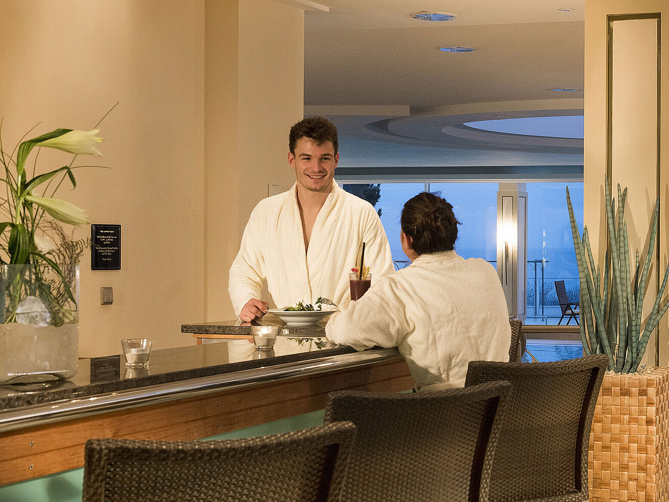Spa area with pool and guests in bathrobes at Maritim Seehotel Timmendorfer Strand.
