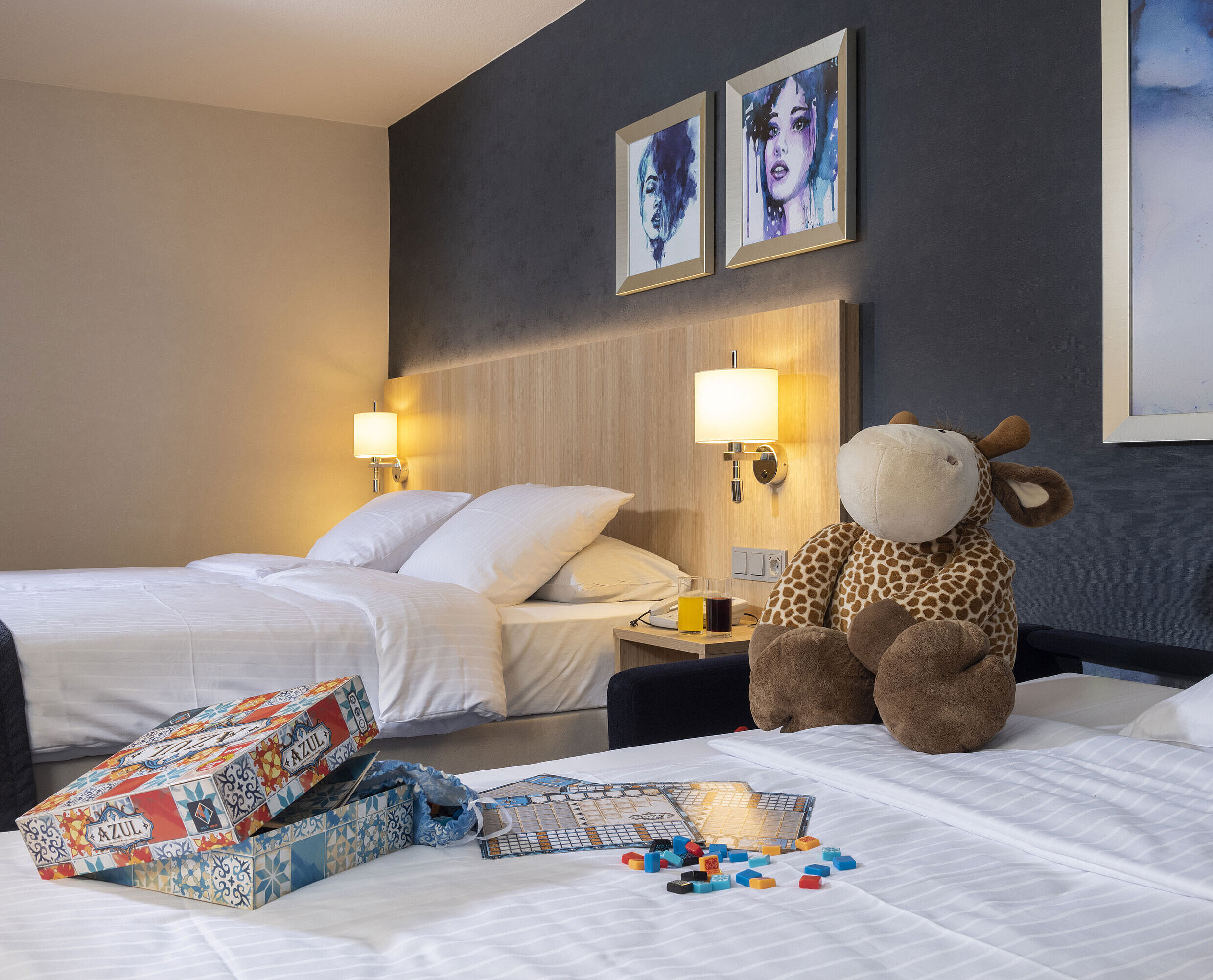 Comfort room Comfort family room at Maritim Hotel Würzburg with plush toy and colorful board game